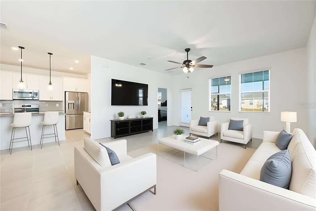 1874 Flourish Avenue Kissimmee, FL 34744 - Photo 3 of 35 a living room with furniture and a flat screen tv