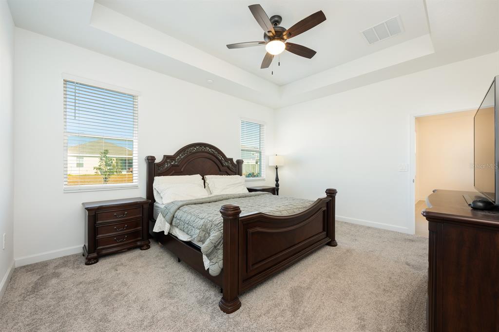 1874 Flourish Avenue Kissimmee, FL 34744 - Photo 10 of 35 a bedroom with a bed and a ceiling fan