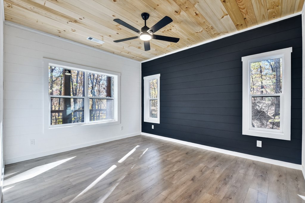 85 Duck Cove Morganton, GA 30560 - Photo 12 of 36 a view of an empty room with a window and wooden floor