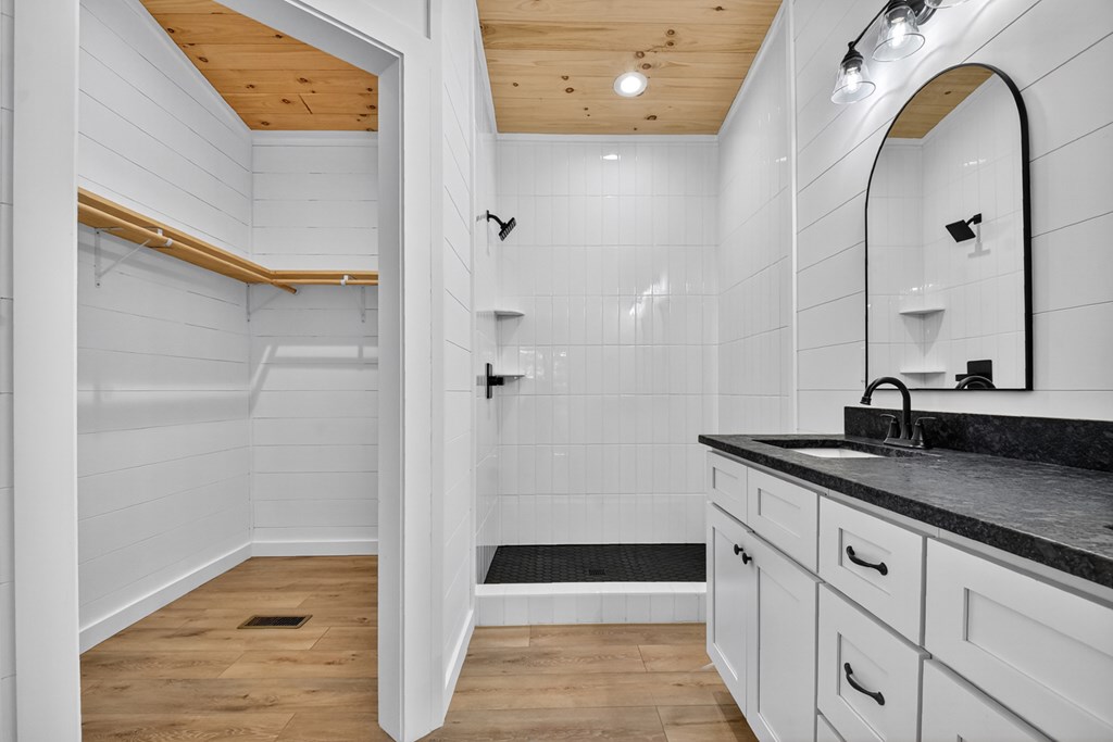 85 Duck Cove Morganton, GA 30560 - Photo 14 of 36 a bathroom with a granite countertop sink a mirror and shower