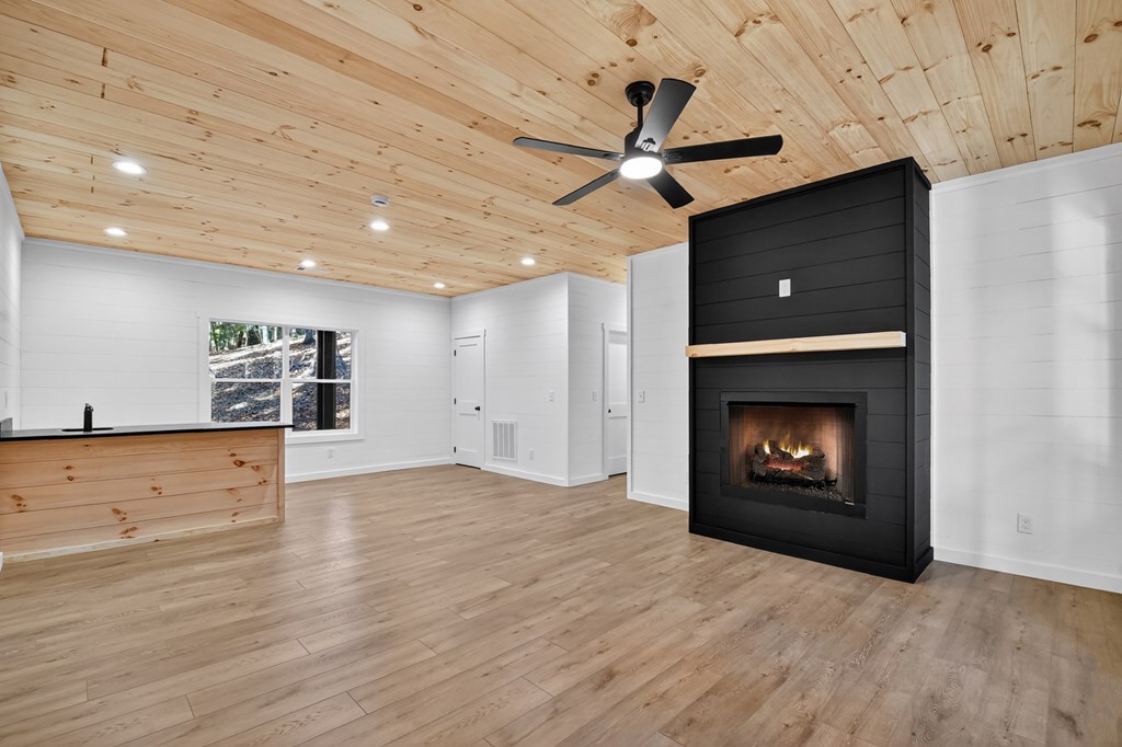 85 Duck Cove Morganton, GA 30560 - Photo 24 of 36 a view of an empty room with a fireplace and a ceiling fan