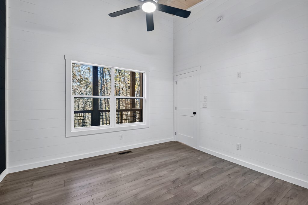 85 Duck Cove Morganton, GA 30560 - Photo 28 of 36 an empty room with wooden floor fan and windows