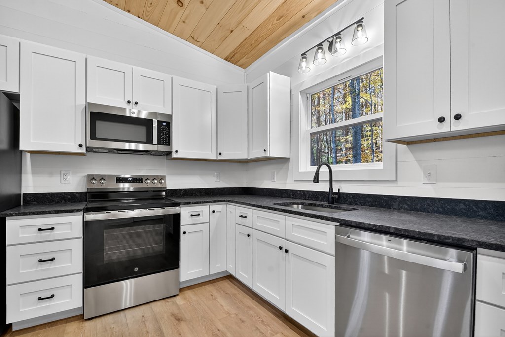 85 Duck Cove Morganton, GA 30560 - Photo 6 of 36 a kitchen with granite countertop white cabinets white stainless steel appliances and a sink
