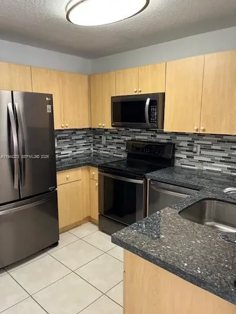a refrigerator freezer sitting in a kitchen