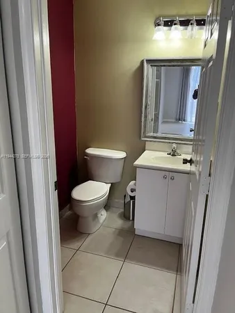 a bathroom with a granite countertop sink a toilet and shower