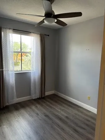 a view of walk in closet with wooden floor