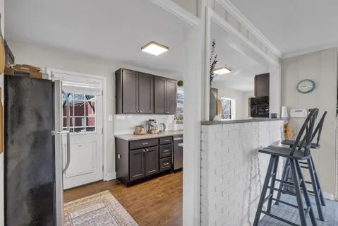 a kitchen with stainless steel appliances granite countertop a refrigerator a stove and a sink