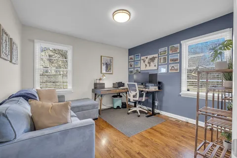 a living room with furniture fireplace and a window