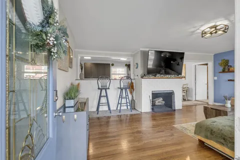 a living room with furniture a fireplace and a flat screen tv