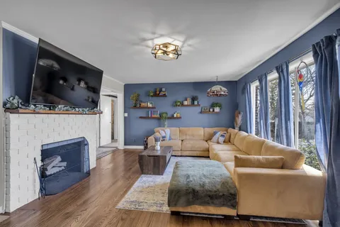 a living room with furniture a flat screen tv and a fireplace