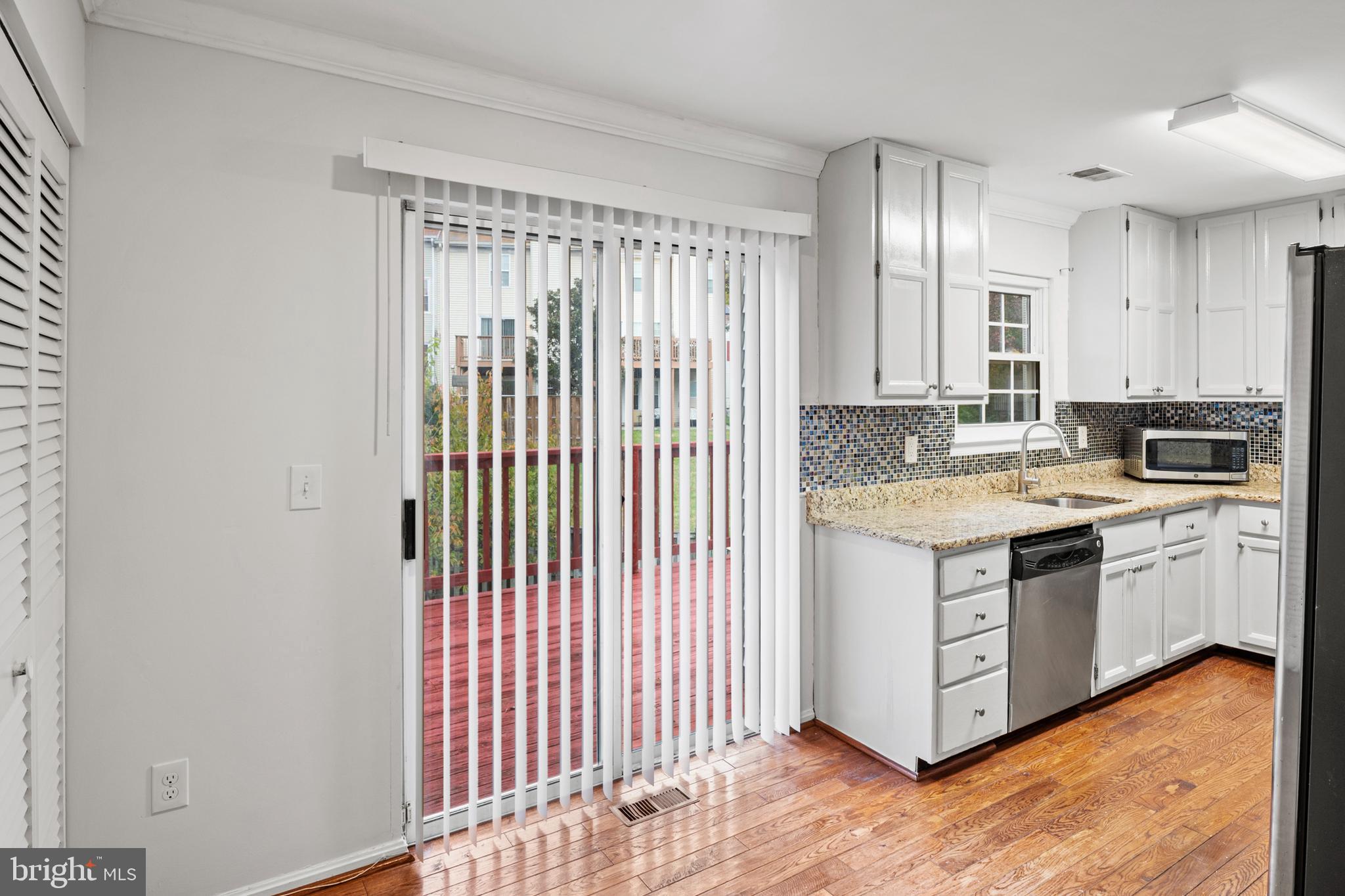 7022 Storch Lane Lanham, MD 20706 - Photo 22 of 44 Sunny & bright kitchen w/ sliding door to deck!