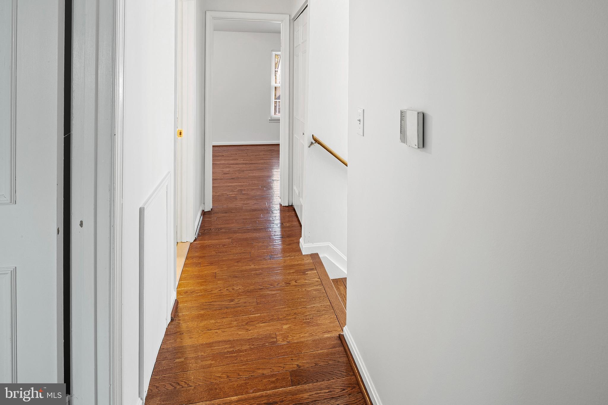 7022 Storch Lane Lanham, MD 20706 - Photo 28 of 44 Hallway w/ hardwoods leading to primary bedroom.
