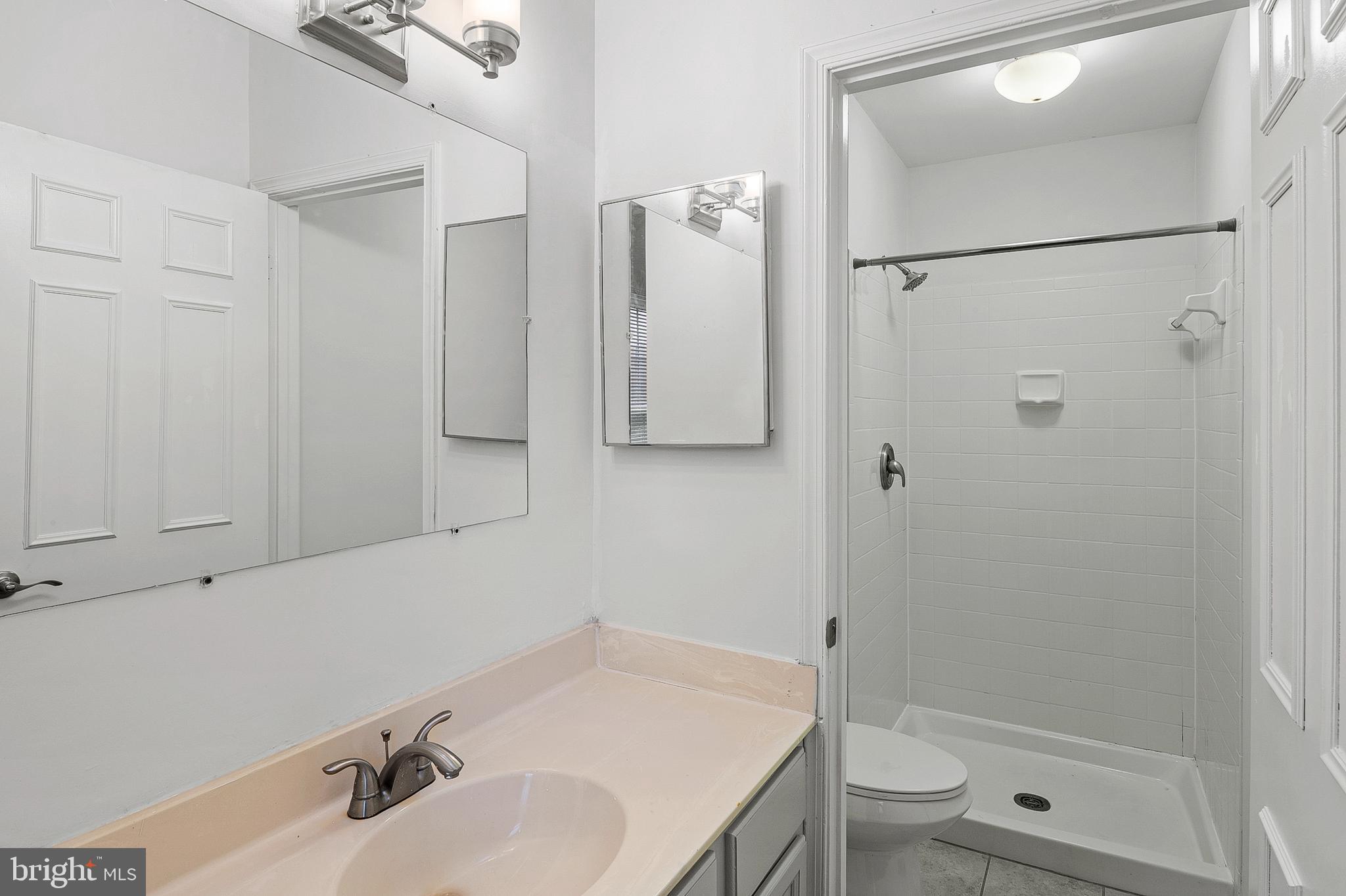 7022 Storch Lane Lanham, MD 20706 - Photo 32 of 44 Primary bathroom with vanity sink & walk-in shower