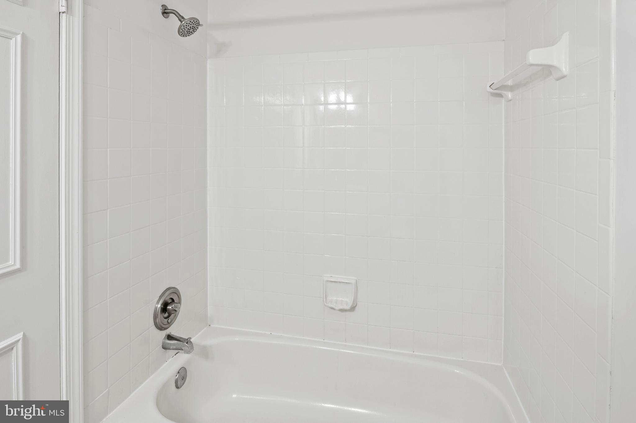 7022 Storch Lane Lanham, MD 20706 - Photo 39 of 44 Hallway bathroom with bathtub & shower.
