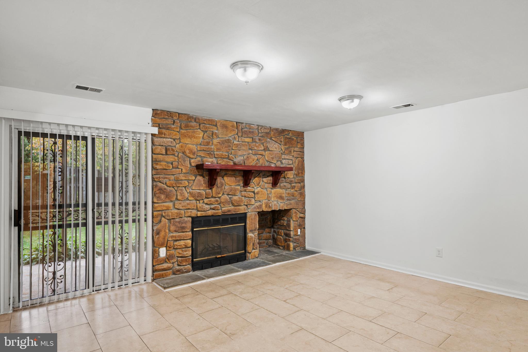 7022 Storch Lane Lanham, MD 20706 - Photo 5 of 44 Basement rec. room w/ stone fireplace & patio door
