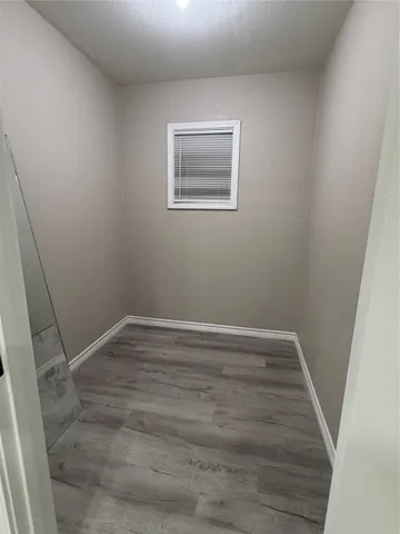 a view of room with window and hardwood floor