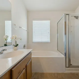 a bathroom with a tub sink and a window