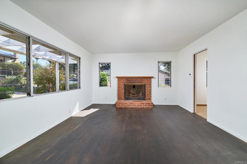 920 Stratford Drive Encinitas, CA 92024 - Photo 5 of 57 an empty room with windows and fireplace