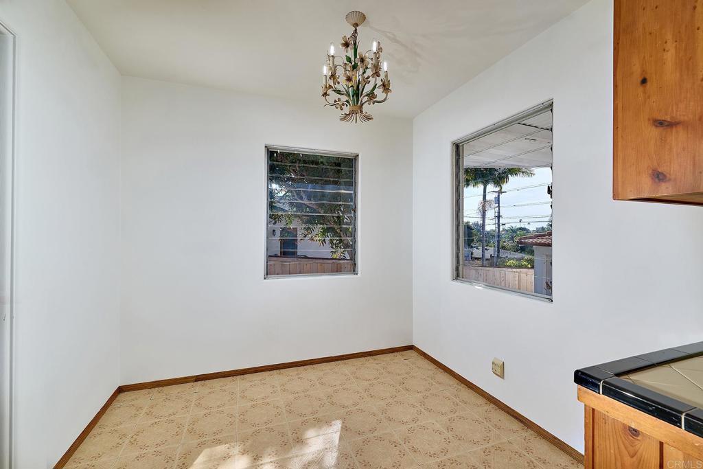 920 Stratford Drive Encinitas, CA 92024 - Photo 7 of 57 an empty room with windows and chandelier