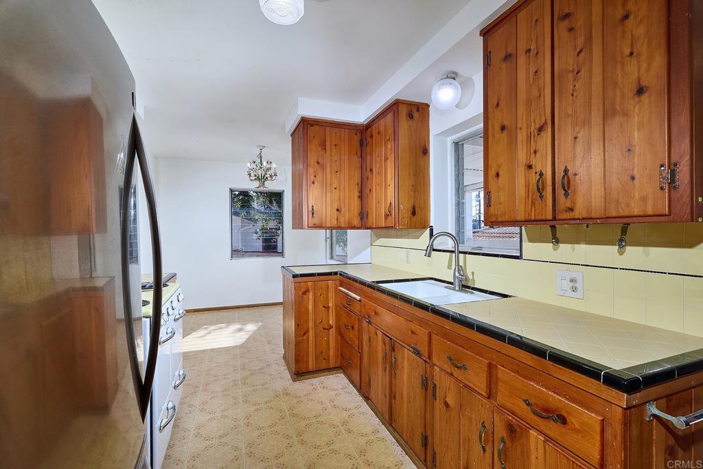 920 Stratford Drive Encinitas, CA 92024 - Photo 9 of 57 a kitchen with a sink and a refrigerator