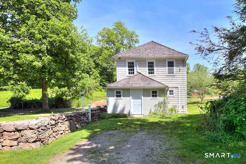 94 Honey Hill Road Wilton, CT 06897 - Photo 1 of 18 a front view of a house with garden