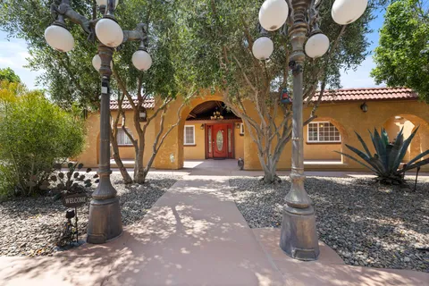 a living room with furniture a kitchen view and a kitchen view