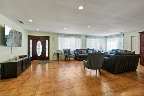 a kitchen with stainless steel appliances kitchen island granite countertop a stove top oven a sink a counter top space and cabinets