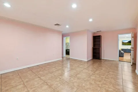 a bedroom with a bed and a lamp on dresser