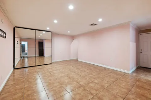 a bathroom with a granite countertop toilet sink and mirror