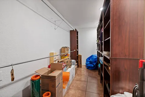 a bathroom with a granite countertop sink a mirror and a shower