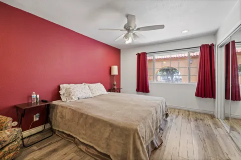 a living room with hard wood floors and a flat screen tv