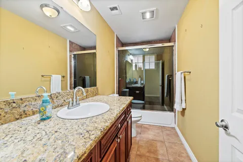 a view of empty room with kitchen and wooden floor
