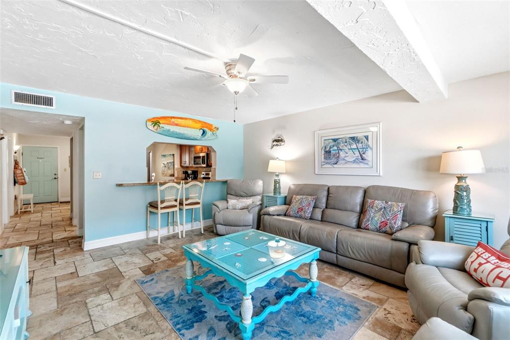 6500 Midnight Pass Road, Unit 208 Sarasota, FL 34242 - Photo 15 of 36 a living room with furniture a lamp and a chandelier