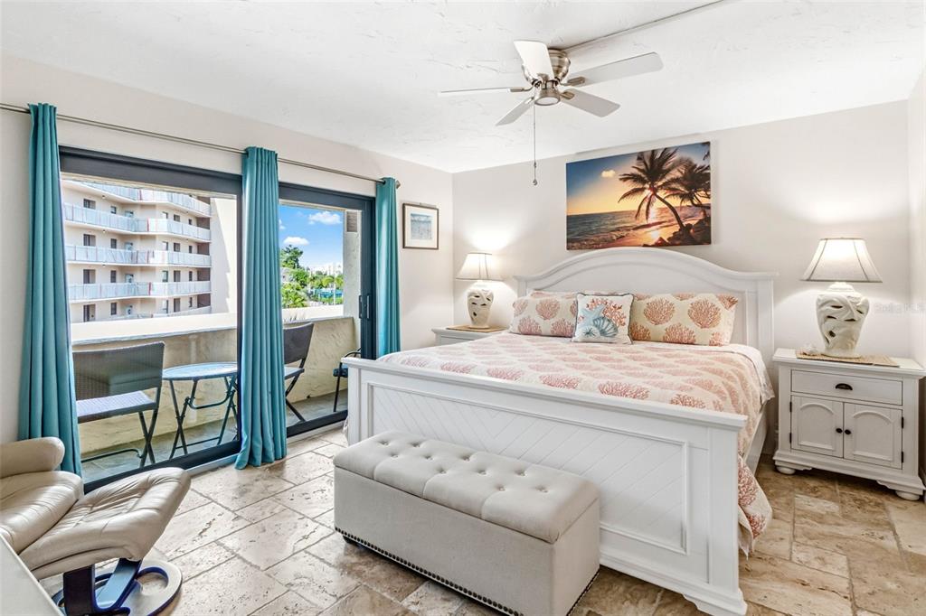 6500 Midnight Pass Road, Unit 208 Sarasota, FL 34242 - Photo 16 of 36 a bedroom with a bed and a painting on the wall