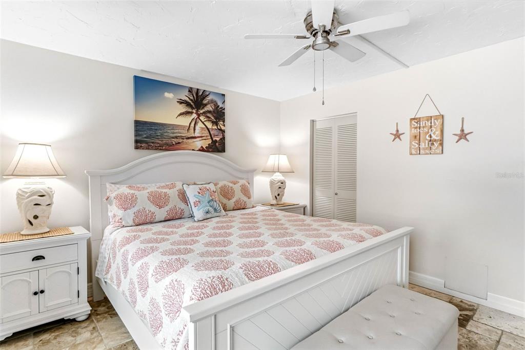 6500 Midnight Pass Road, Unit 208 Sarasota, FL 34242 - Photo 17 of 36 a bedroom with a bed and a chandelier