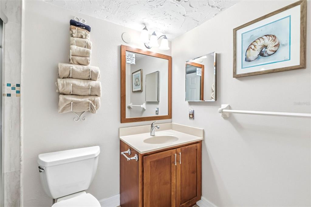 6500 Midnight Pass Road, Unit 208 Sarasota, FL 34242 - Photo 18 of 36 a bathroom with a sink and a mirror