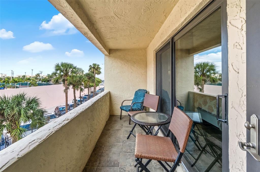 6500 Midnight Pass Road, Unit 208 Sarasota, FL 34242 - Photo 22 of 36 a balcony with chairs and a table