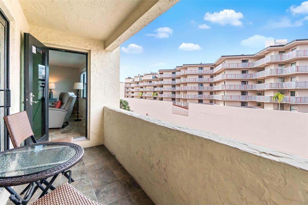 6500 Midnight Pass Road, Unit 208 Sarasota, FL 34242 - Photo 23 of 36 a living room with a table and chairs