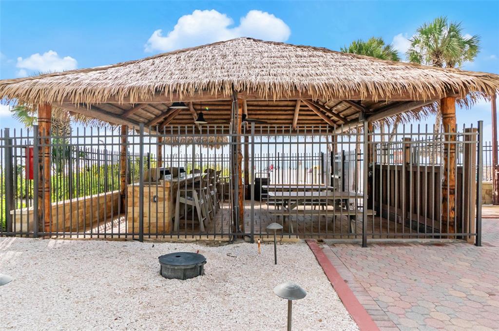6500 Midnight Pass Road, Unit 208 Sarasota, FL 34242 - Photo 26 of 36 a view of a patio with table and chairs