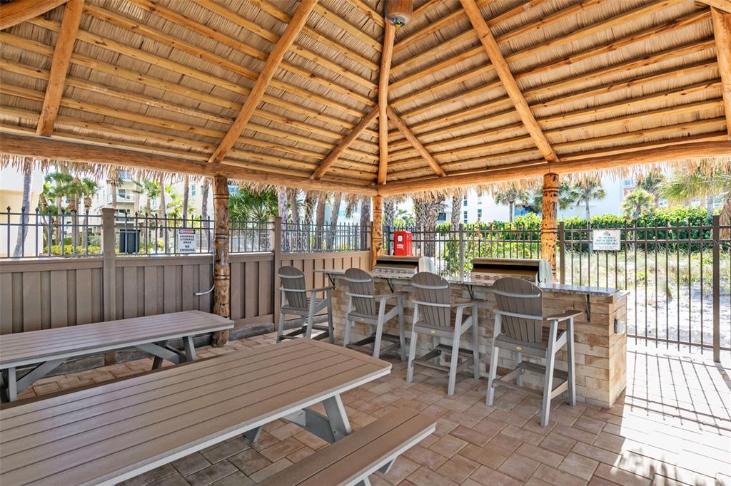 6500 Midnight Pass Road, Unit 208 Sarasota, FL 34242 - Photo 27 of 36 a view of a patio with a table and chairs