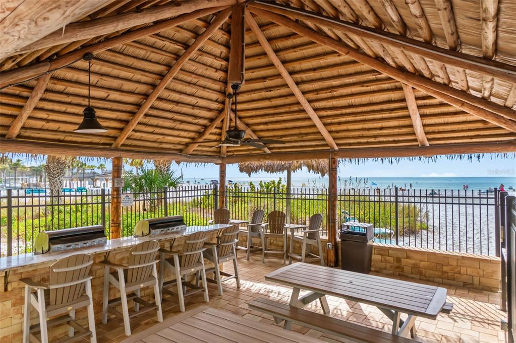 6500 Midnight Pass Road, Unit 208 Sarasota, FL 34242 - Photo 28 of 36 a view of a patio with a table chairs and wooden floor