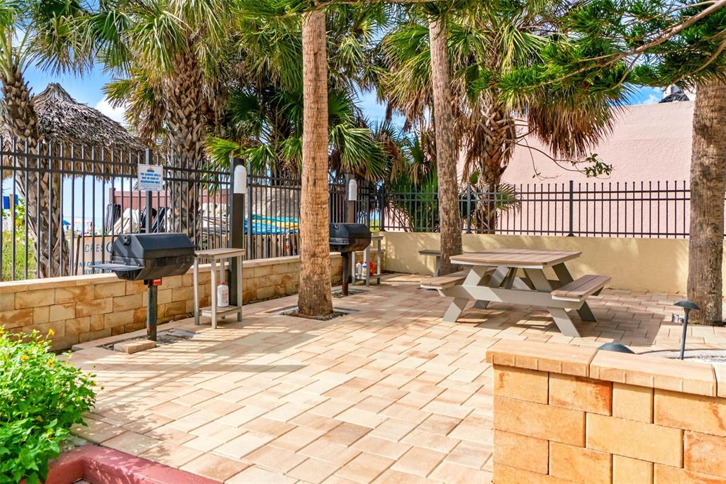 6500 Midnight Pass Road, Unit 208 Sarasota, FL 34242 - Photo 30 of 36 a view of a chair and tables on the patio