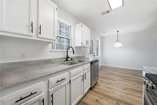 a kitchen with sink and cabinets