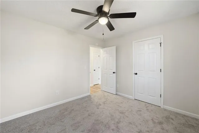 an empty room with ceiling fan