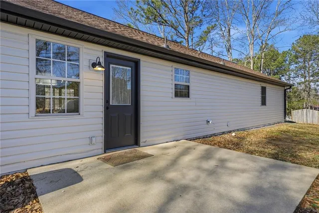 a view of a house with snow on the road