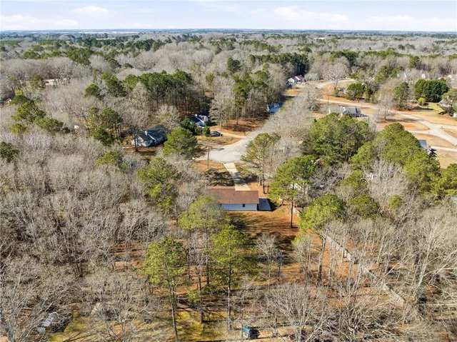 an aerial view of forest with houses