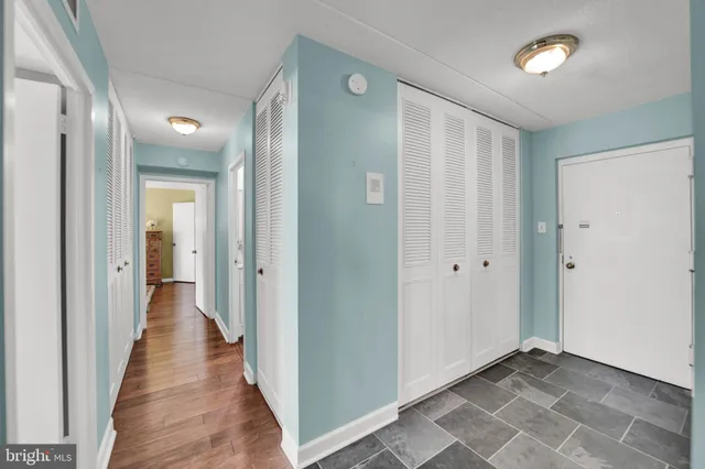 a view of a hallway with wooden floor