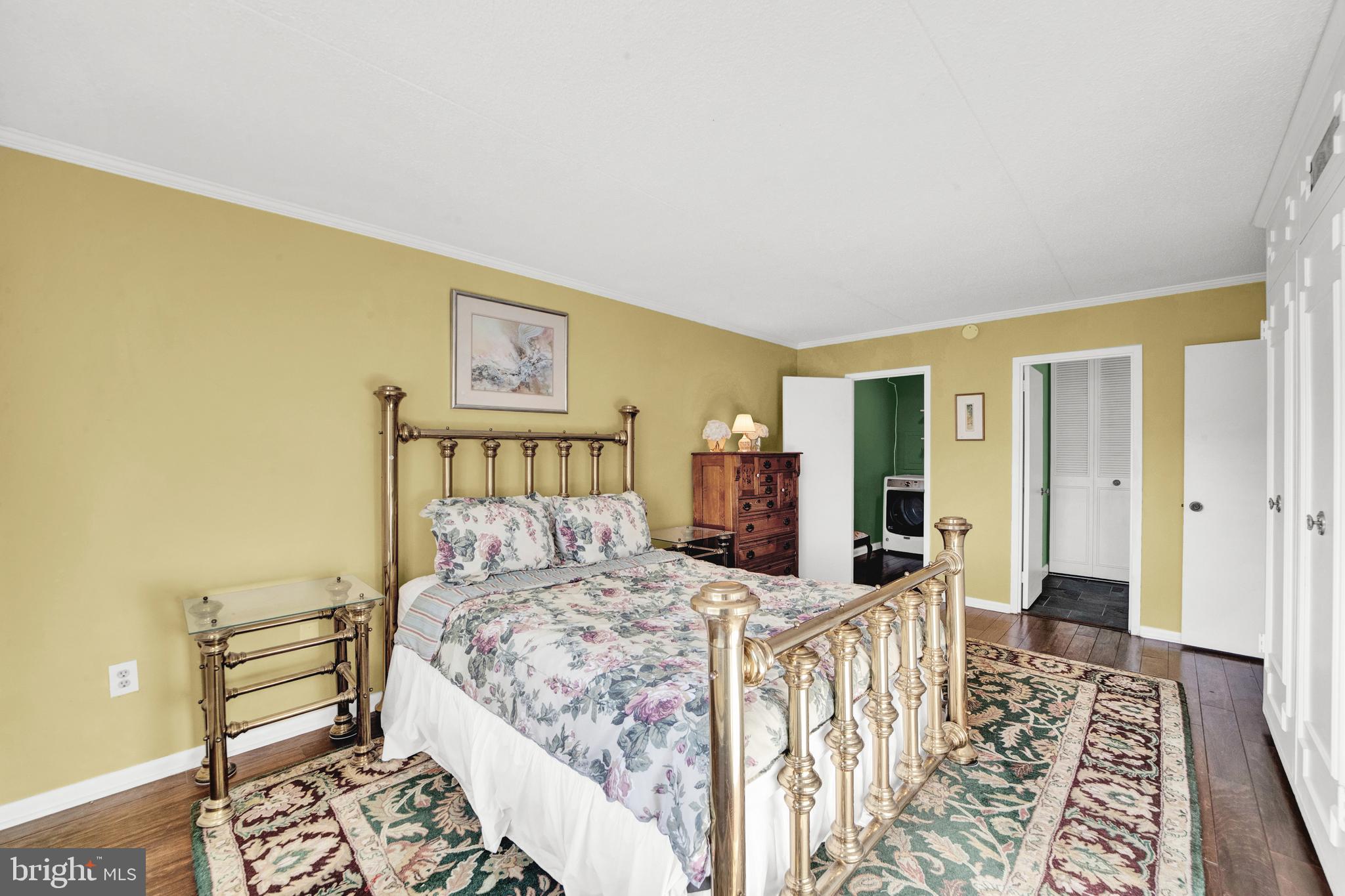 860 Lower Ferry Road, Unit 5P Ewing, NJ 08628 - Photo 15 of 29 a bedroom with a bed and wooden floor