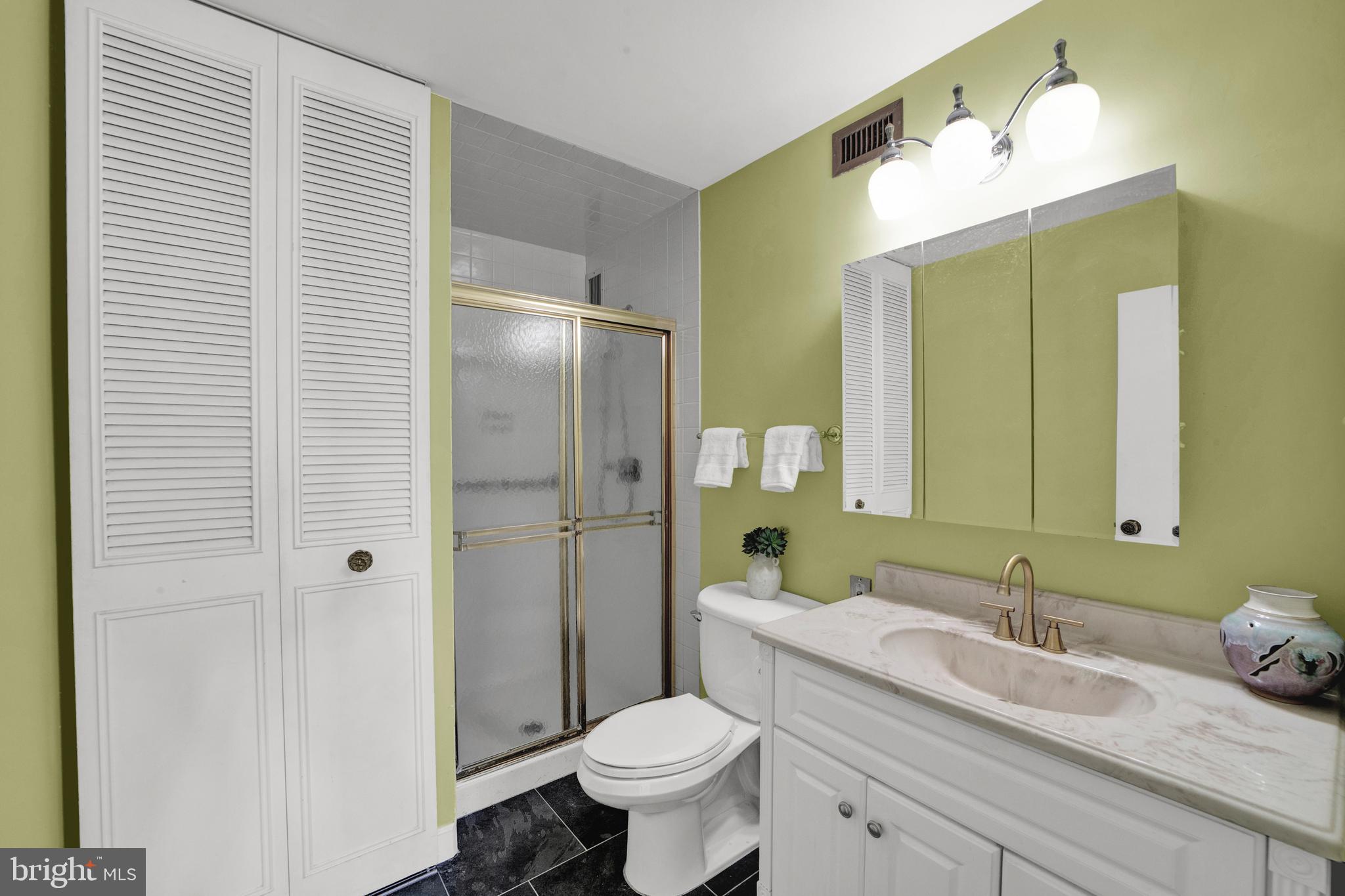 860 Lower Ferry Road, Unit 5P Ewing, NJ 08628 - Photo 17 of 29 a bathroom with a granite countertop sink toilet and shower