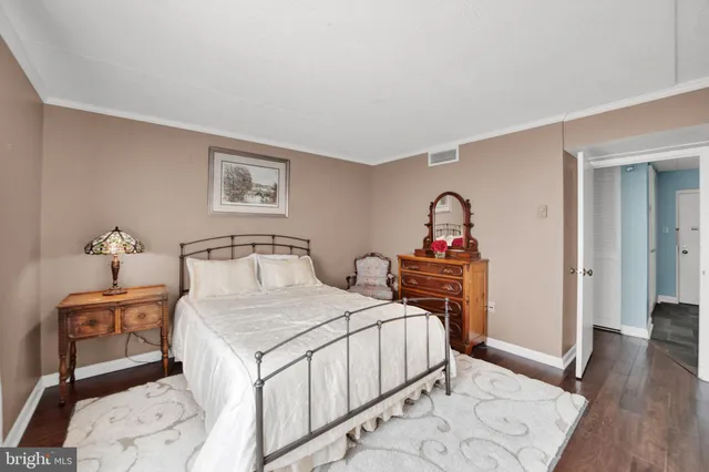 a bedroom with a bed and a dresser in it